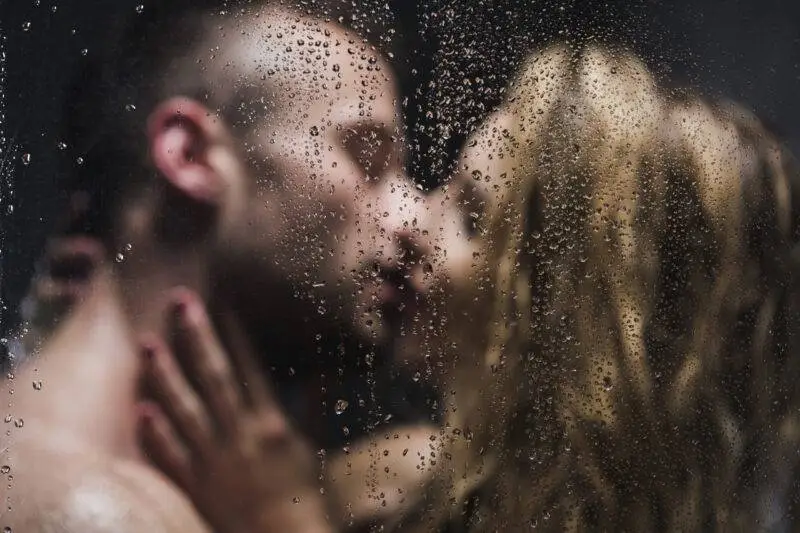 Blurred image of a sexy pair kissing in the shower
